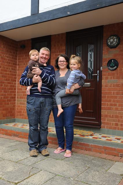 kerry john and kids outside their home with loft converted by apex loft .com 